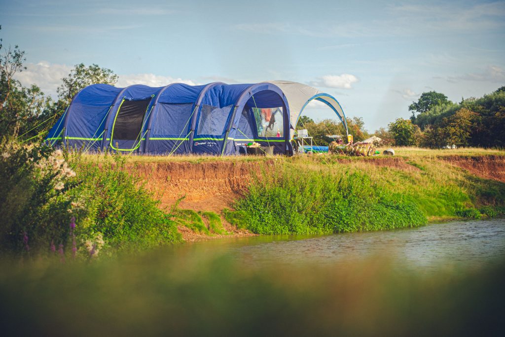 Riverside camping pitch, tent camping at Wild Canvas Camping, UK